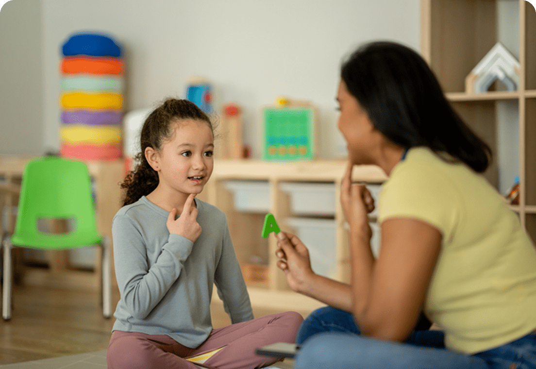 Child learning with teacher in classroom