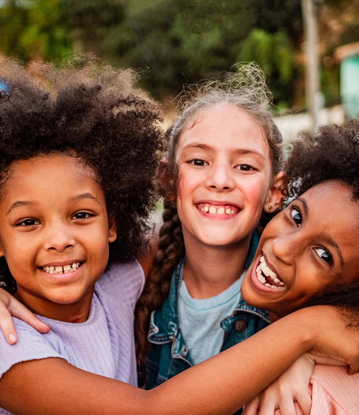 Smiling kids hugging outdoors