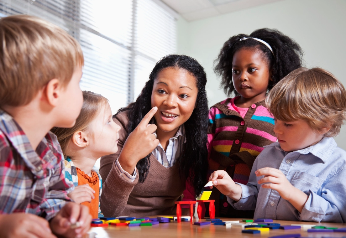 Educator guiding kids in classroom